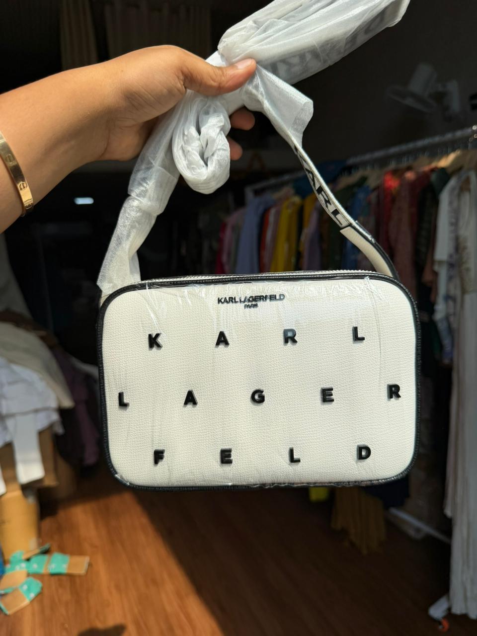Karl Lagerfeld Paris Maybelle Camera Crossbody bag in white with black lettering.
