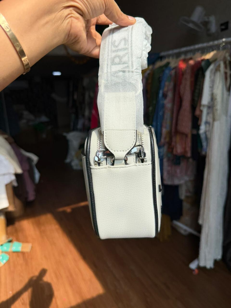 Karl Lagerfeld Paris Maybelle Camera Crossbody bag in white with black lettering.